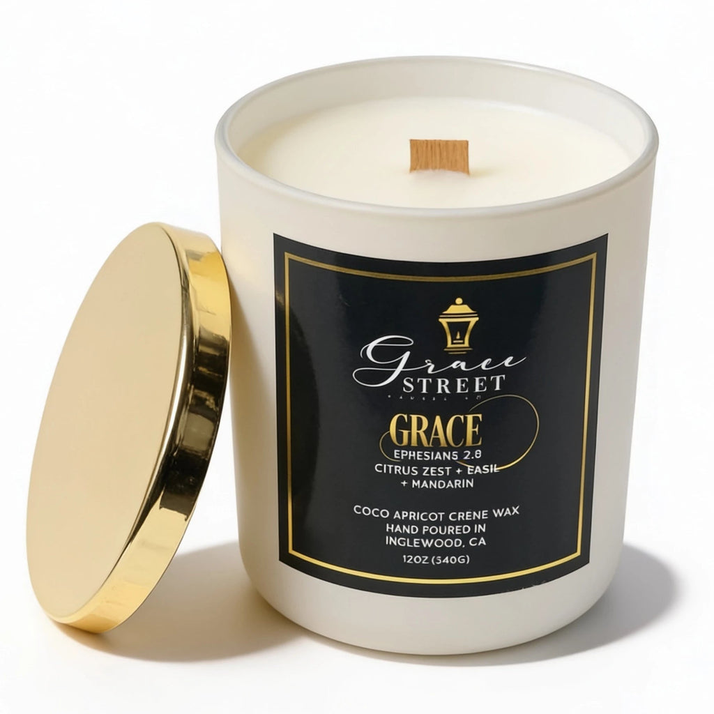 Grace Street 'Grace' scented candle in a white glass jar with a black and gold label, shown with its gold lid leaning against the jar on a white background.