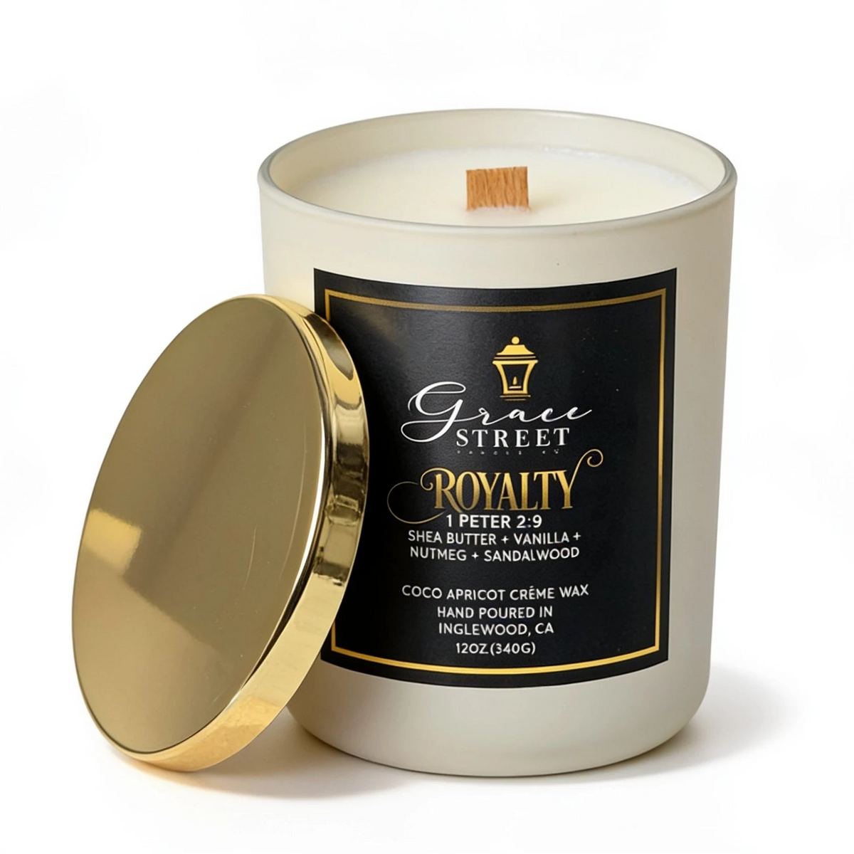 Grace Street Royalty scented candle in a white glass jar with a black and gold label, shown with its gold lid leaning against the jar on a white background.
