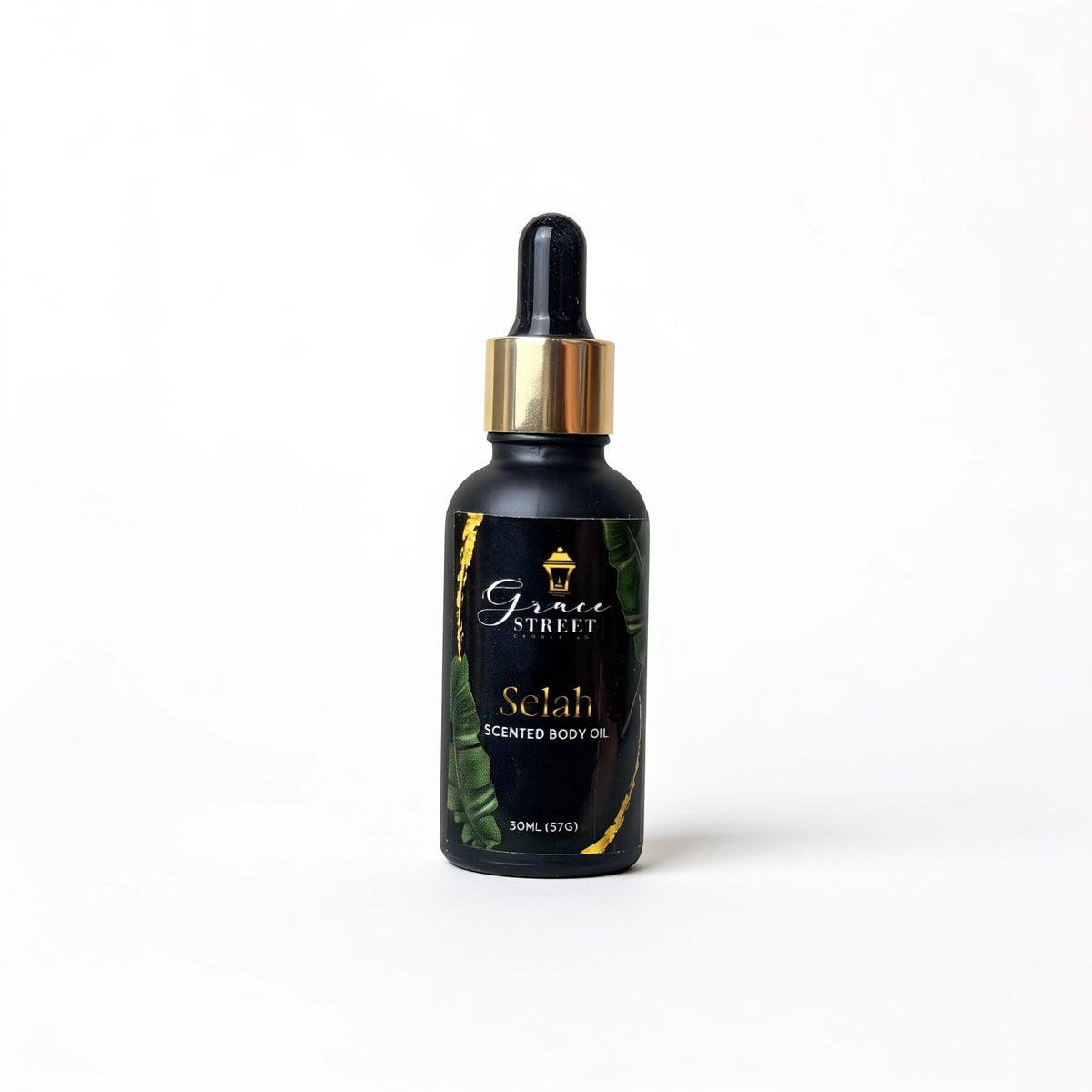 A 30ml bottle of Grace Street Selah Scented Body Oil, featuring a black glass bottle with a gold collar and a black label with gold lettering and green leaf accents, set against a plain white background.